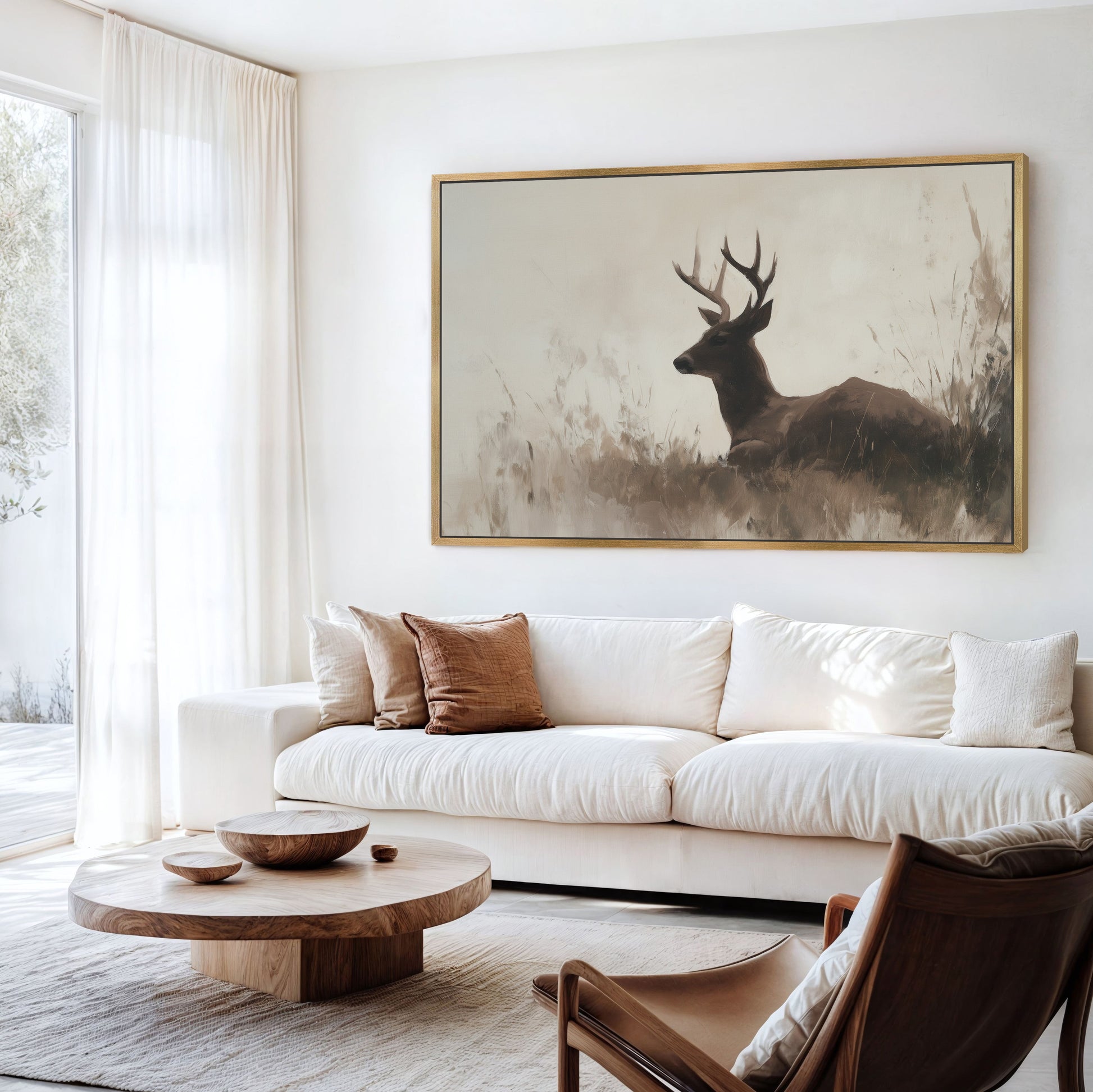 Haven Canvas Print of a deer resting in soft grasses with warm, neutral tones hanging above a white sofa in a bright living room