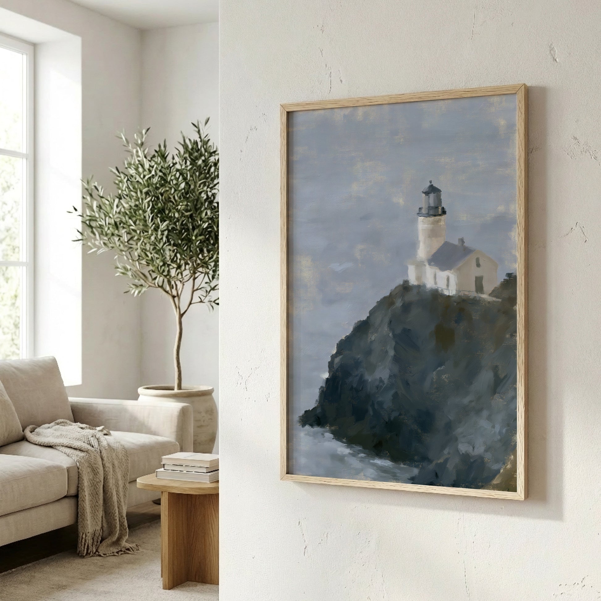 a framed painting of a lighthouse on a cliff, hanging on a wall in a living room.