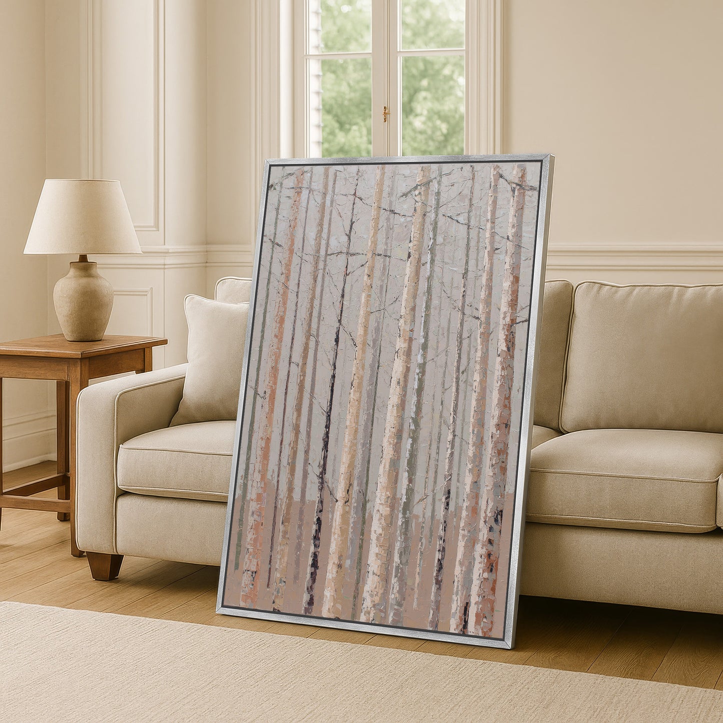 a large framed painting of a forest scene, with tall trees and a serene atmosphere, placed in a living room setting.