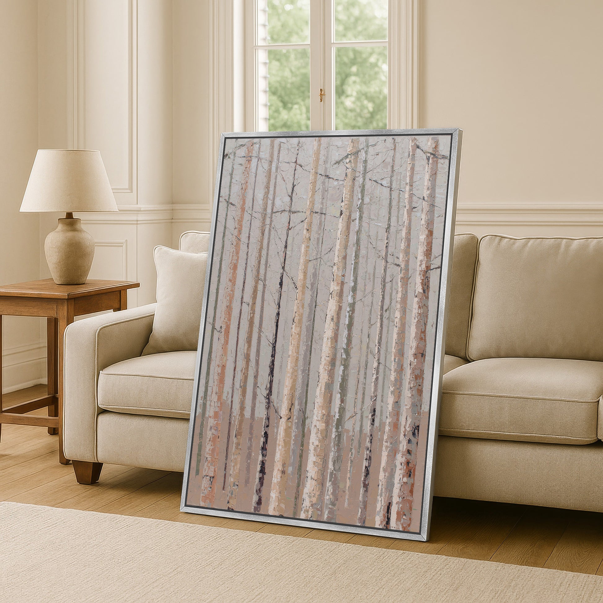 a large framed painting of a forest scene, with tall trees and a serene atmosphere, placed in a living room setting.