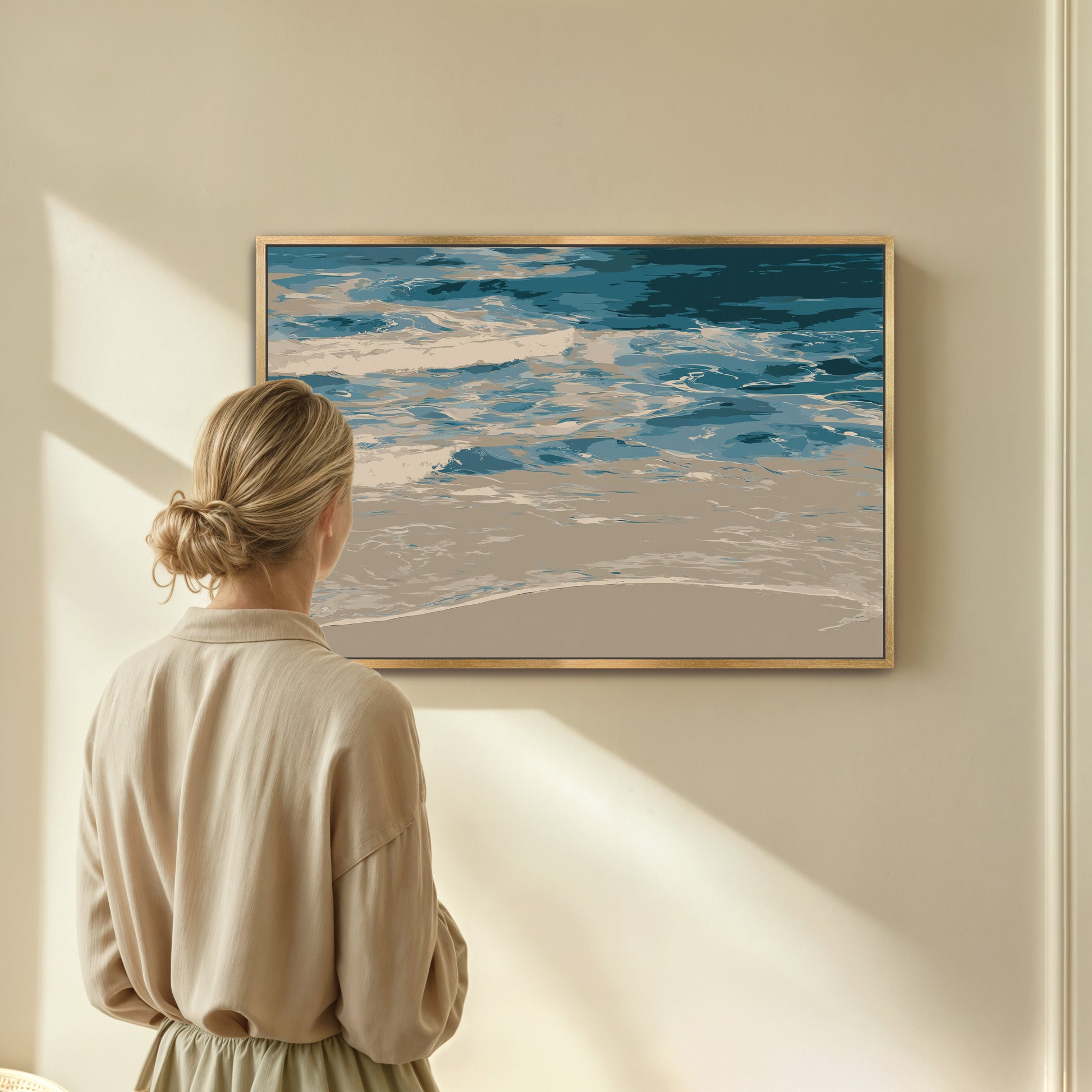 Woman viewing Marin Canvas Print showcasing abstract shoreline in blues and neutrals in modern room