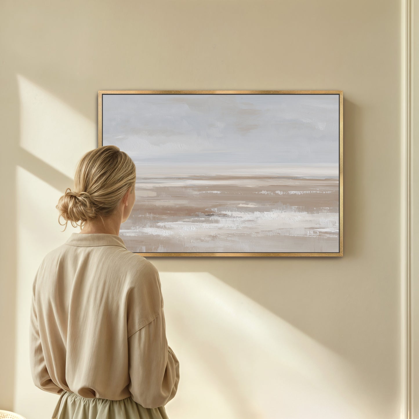 Minimalist barren canvas print with taupe and cream landscape in light wood frame on wall