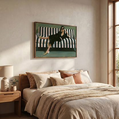 a bedroom with a large bed, a framed painting of a woman on a striped couch, and a lamp on a side table.