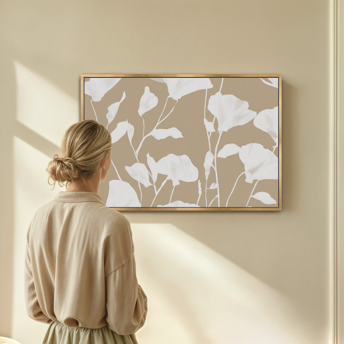 Driftleaf Canvas Print with white floral silhouettes on beige background in natural wood frame displayed in minimalist room