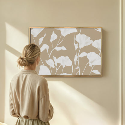 Driftleaf Canvas Print with white floral silhouettes on beige background in natural wood frame displayed in minimalist room