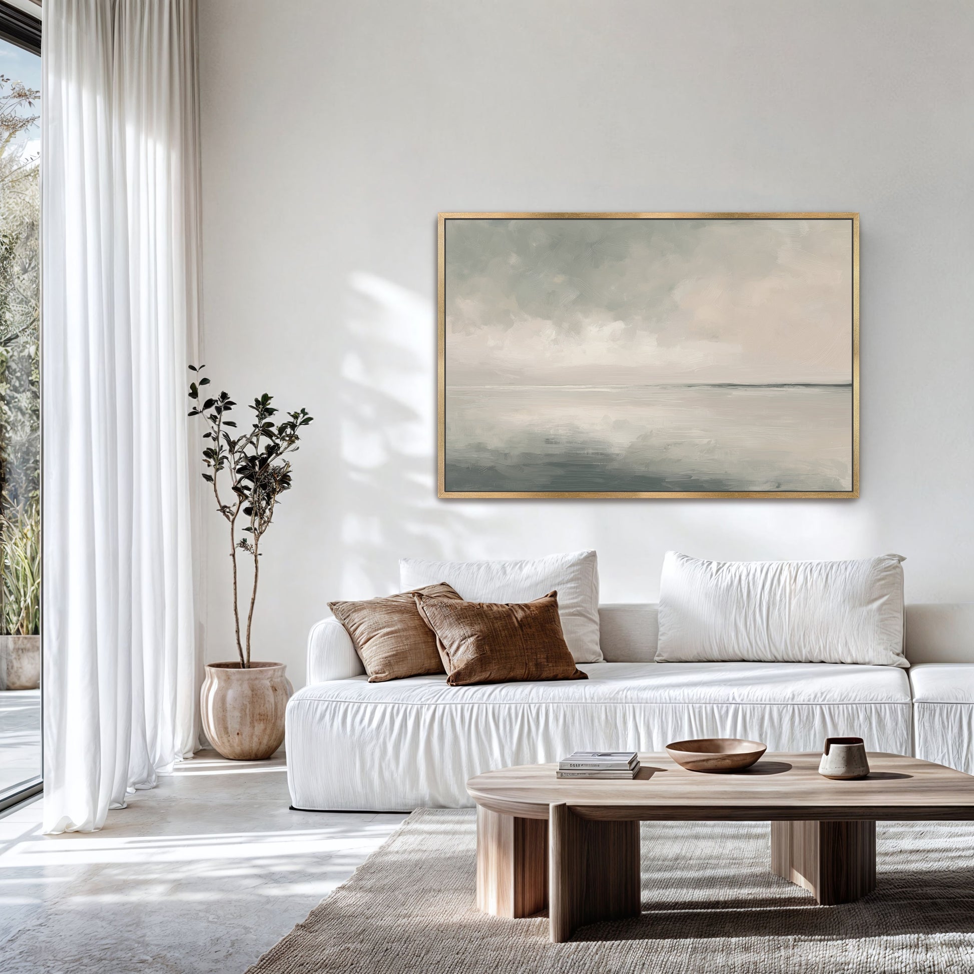 Aure Cavas Print framed landscape art of serene sky and sea in neutral tones above white sofa in modern living room