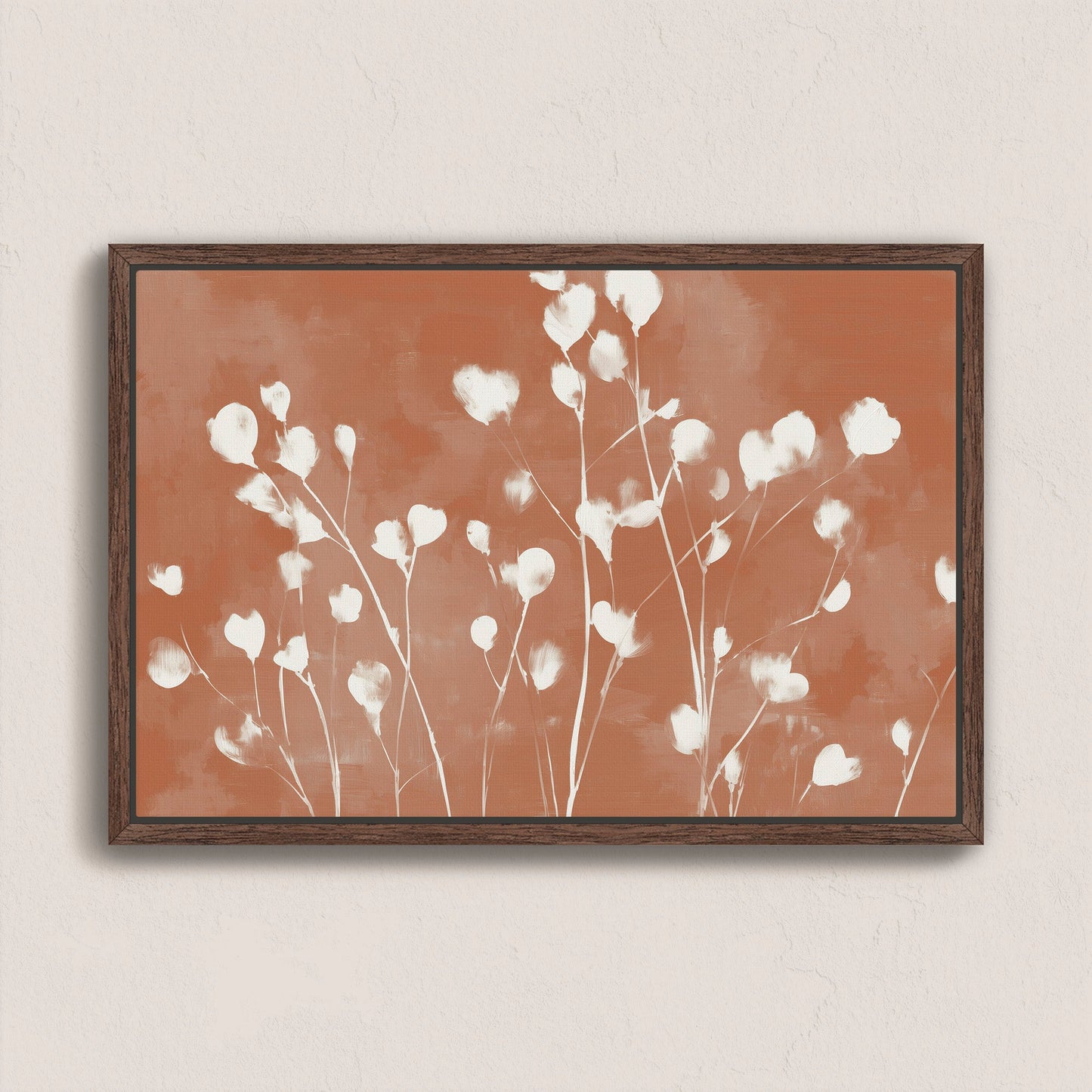 Ember canvas print with white petals on terracotta background in a walnut frame