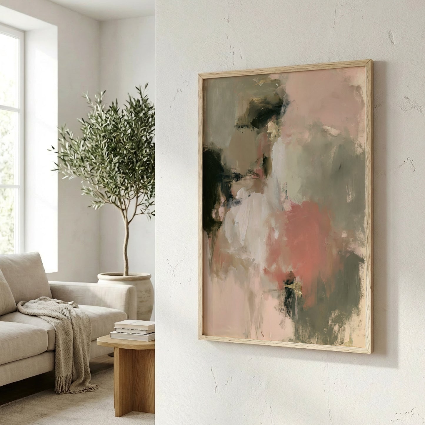 a living room with a large abstract painting hanging on the wall, a comfortable couch, and a potted plant.