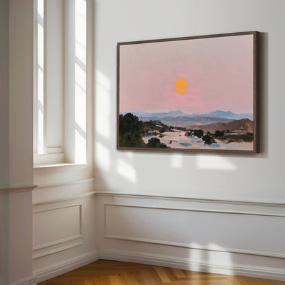 a large painting of a sunset landscape hanging on a white wall in a room with a window.