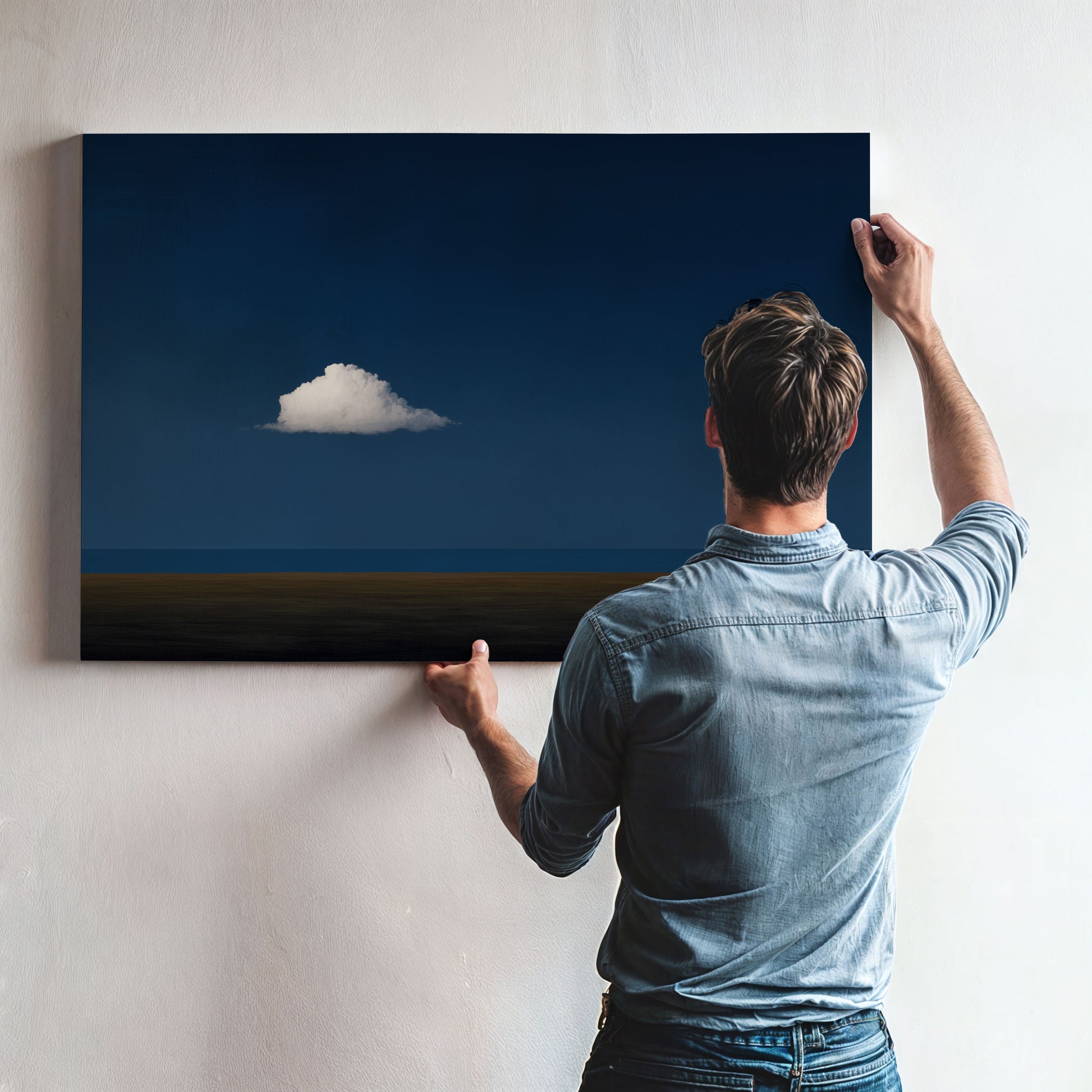 Man hanging Nimbus Canvas Print featuring solitary white cloud on deep blue horizon