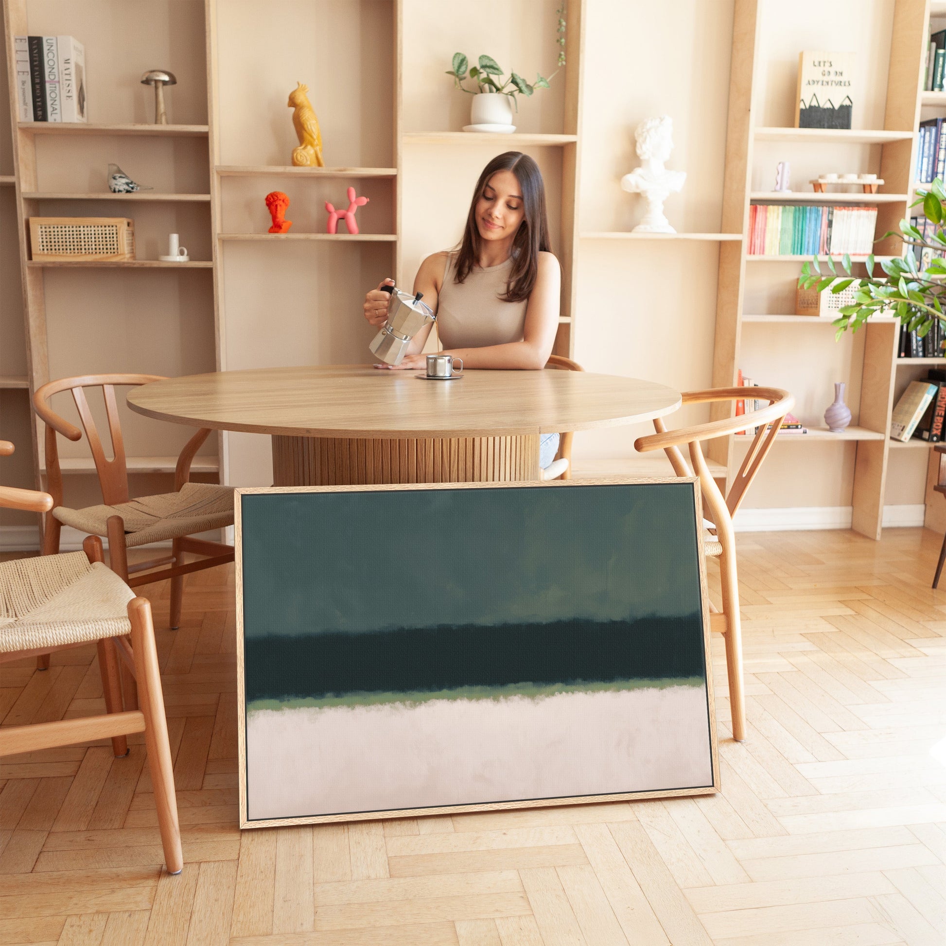 modern living room with minimal decor and Shade Canvas Print leaning against wooden round dining table