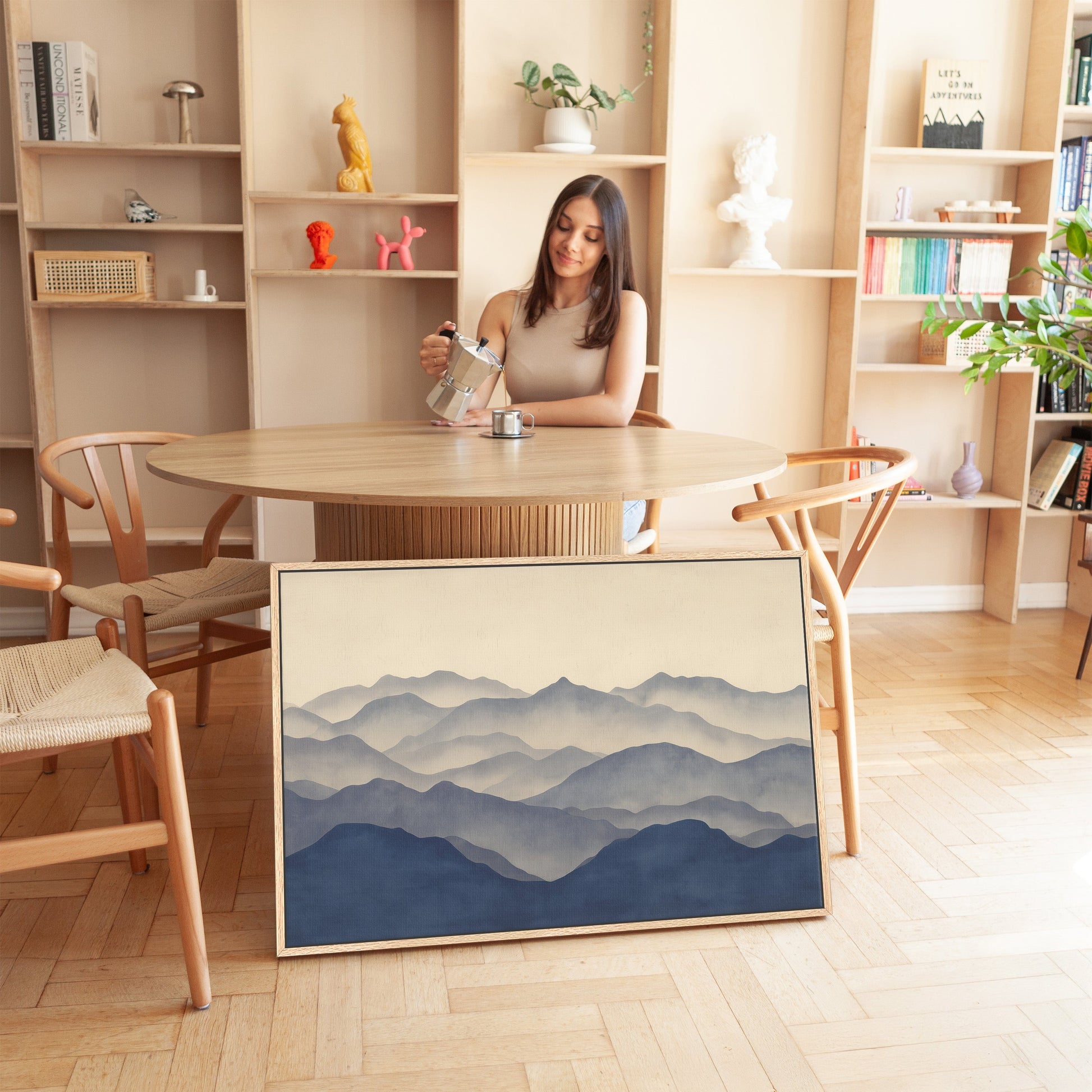 Veil Canvas Print featuring layered mountain silhouettes in indigo and beige gradient, displayed in a modern minimalist room.