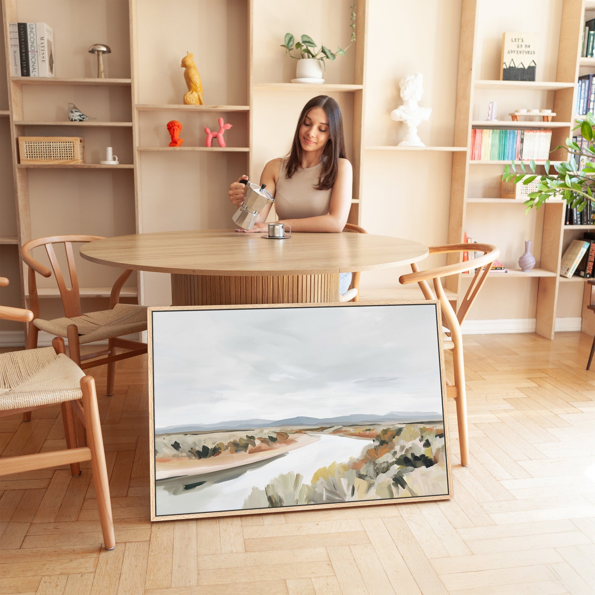 Mesa canvas print of a tranquil modern desert landscape with flowing river and muted earth tones in a minimalist room