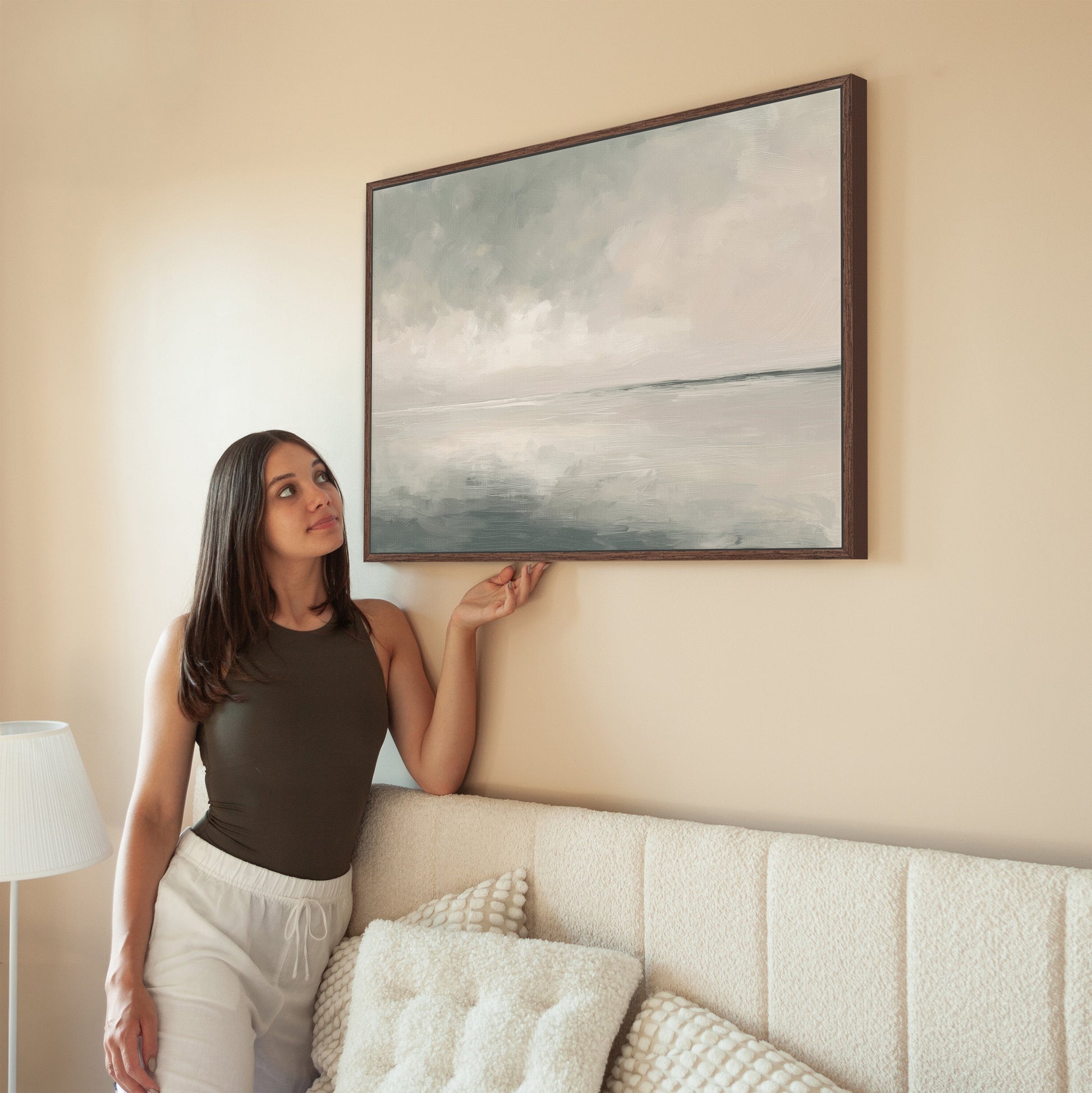 Aure Cavas Print wall art with serene sky and sea in neutral tones above beige sofa