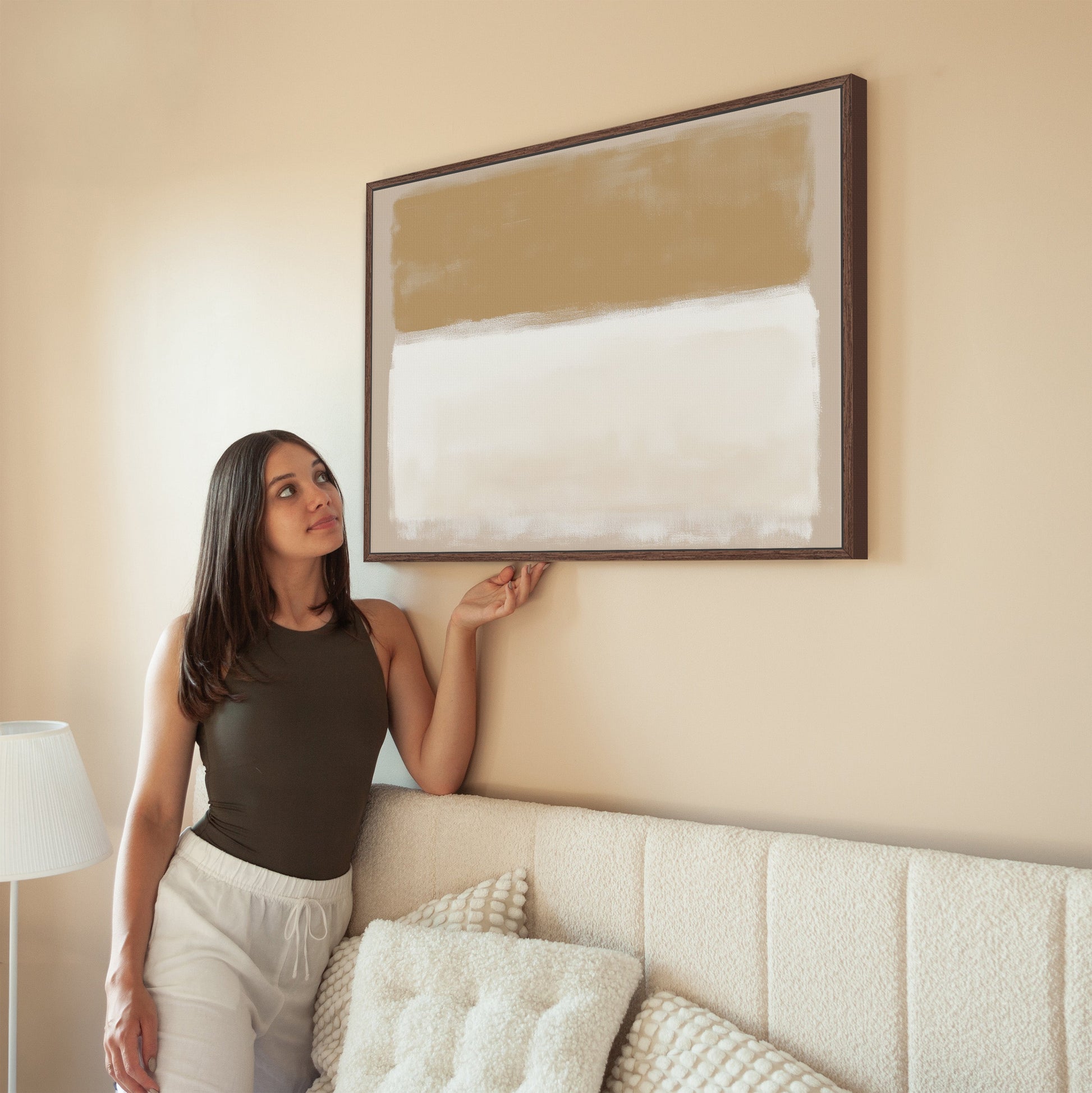 Sienna Canvas Print framed abstract art in warm golden and ivory tones hanging on living room wall above beige sofa