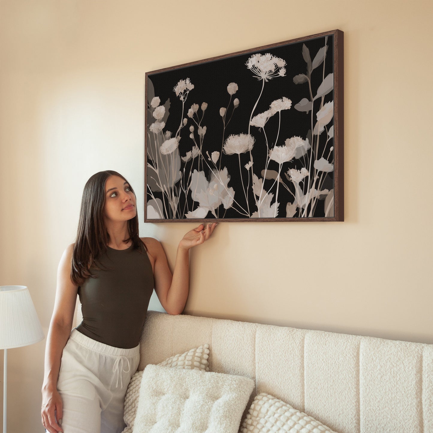 Modern Shadow Bloom canvas art with neutral wildflowers on black background in wooden frame displayed in living room