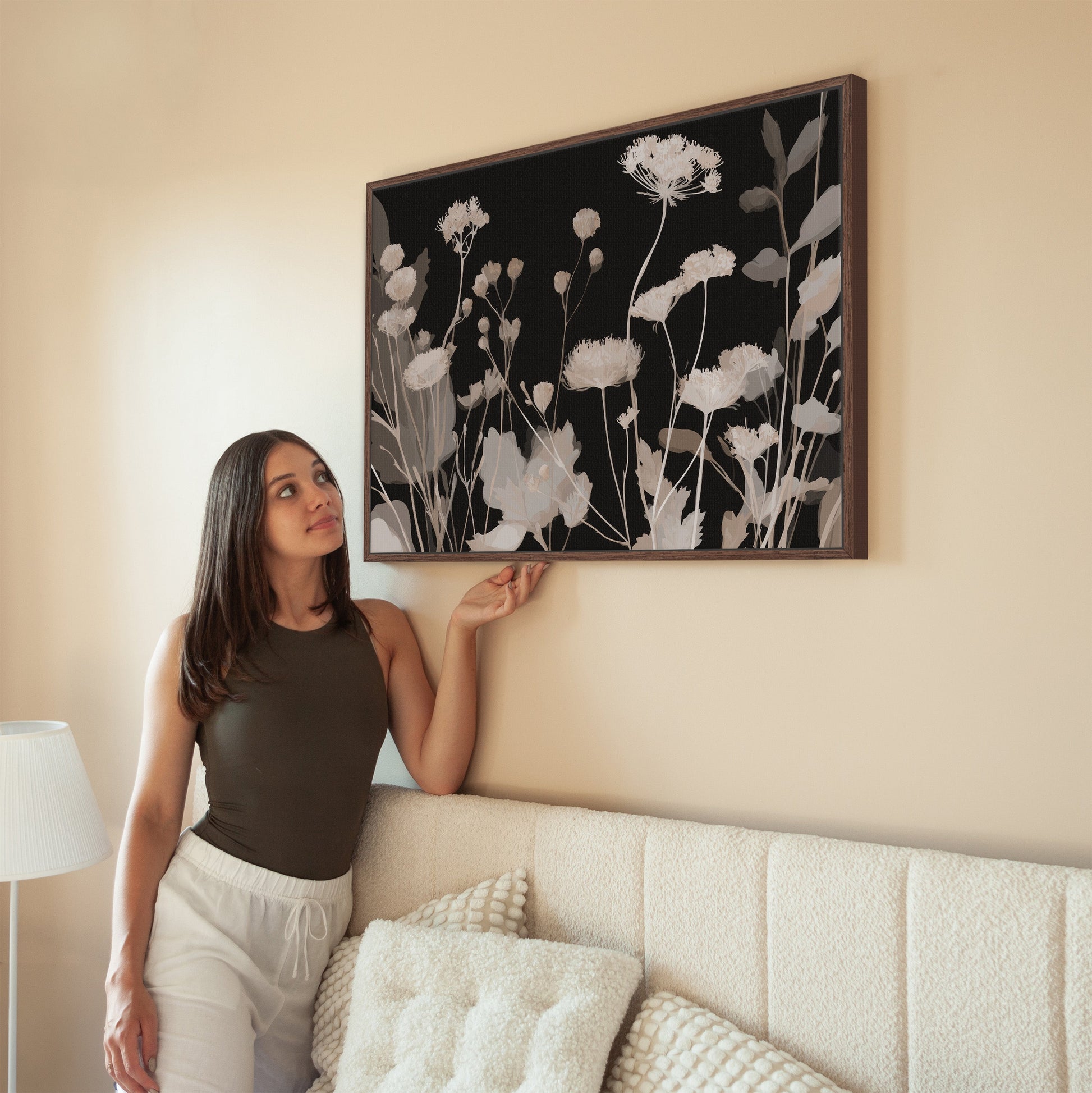 Modern Shadow Bloom canvas art with neutral wildflowers on black background in wooden frame displayed in living room
