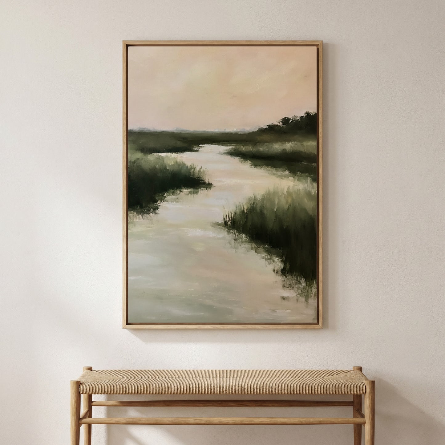 a large painting of a serene landscape with a river and lush greenery, hanging on a wall above a wooden bench.