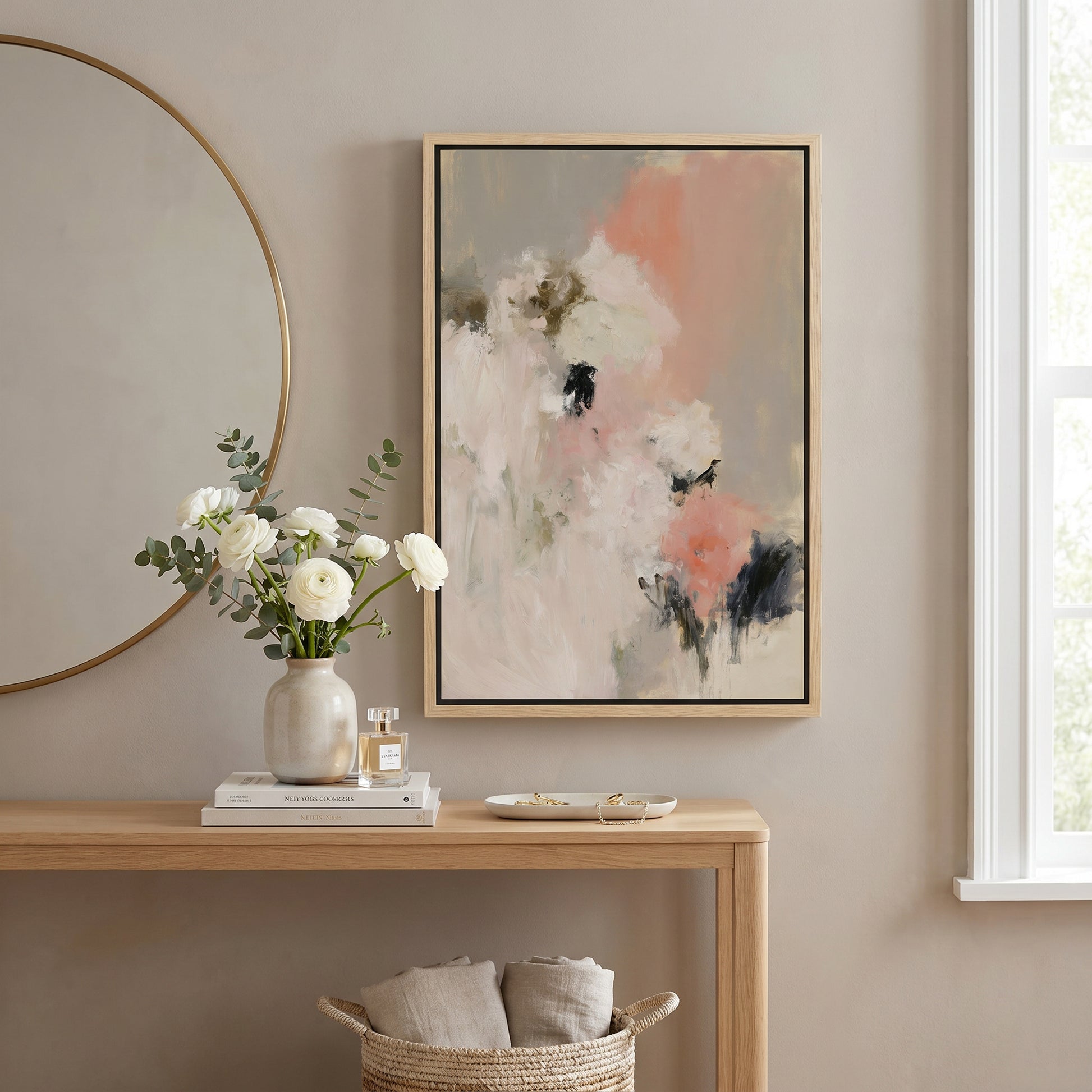 a wooden console table with a vase of white flowers, a framed abstract painting, and a mirror on the wall.