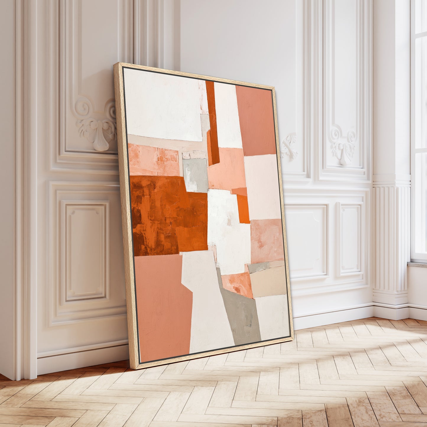 a large abstract painting with a mix of orange, white, and gray colors, displayed on a wooden floor against a white wall.