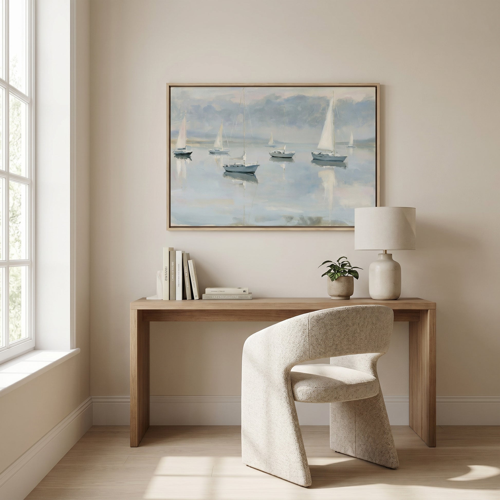 a serene and modern workspace with a wooden desk, a comfortable white chair, and a framed painting of sailboats on the wall.