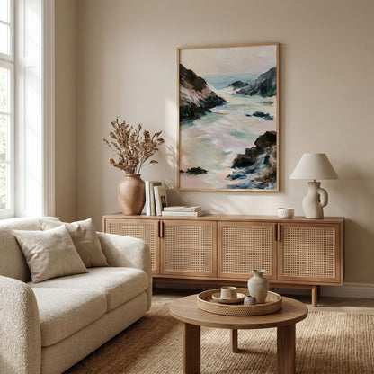 a serene living room with a large painting of a coastal landscape hanging on the wall, a beige sofa, a wooden sideboard, and a round coffee table with a tray.