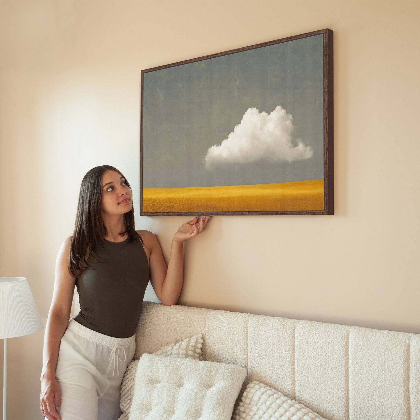 Mellow Canvas Print featuring a single white cloud above a golden plain in a minimalist living room setting