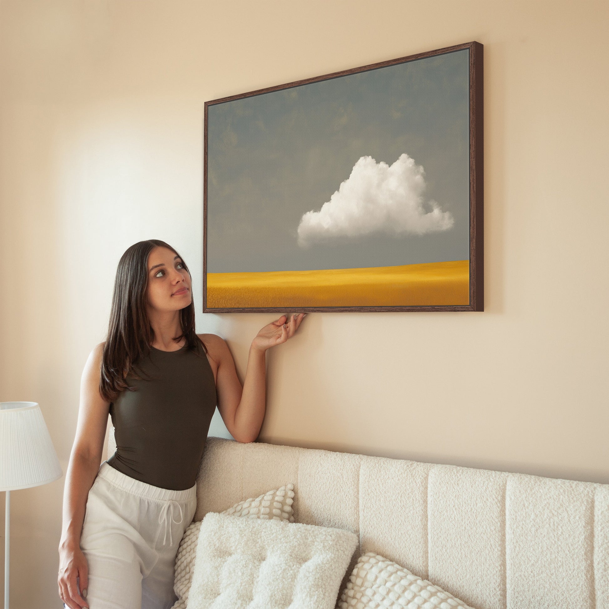 Mellow Canvas Print featuring a single white cloud above a golden plain in a minimalist living room setting