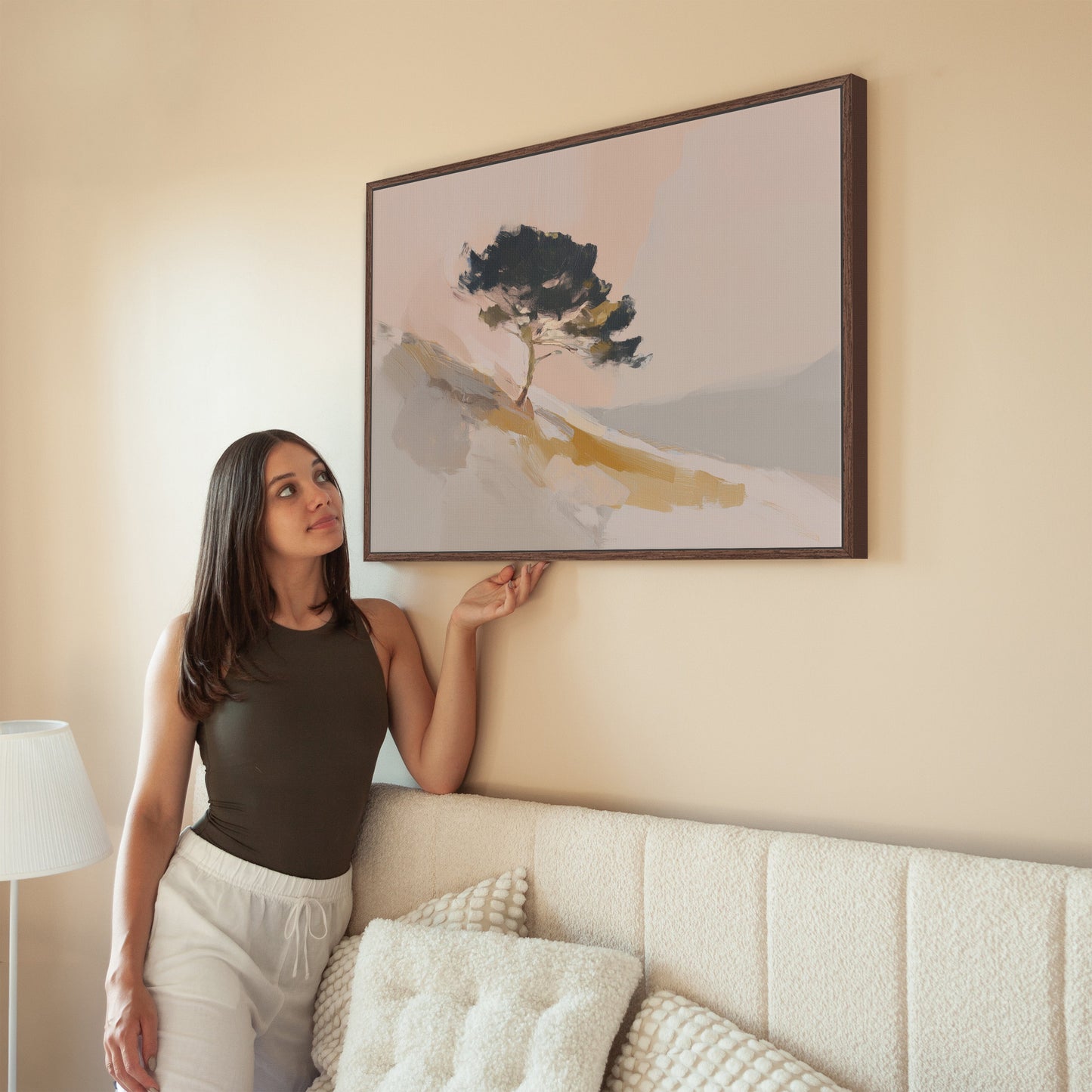 Arbor canvas wall art showing a lone pine tree on a sunlit hillside with warm neutral tones, framed and displayed in a modern living room.