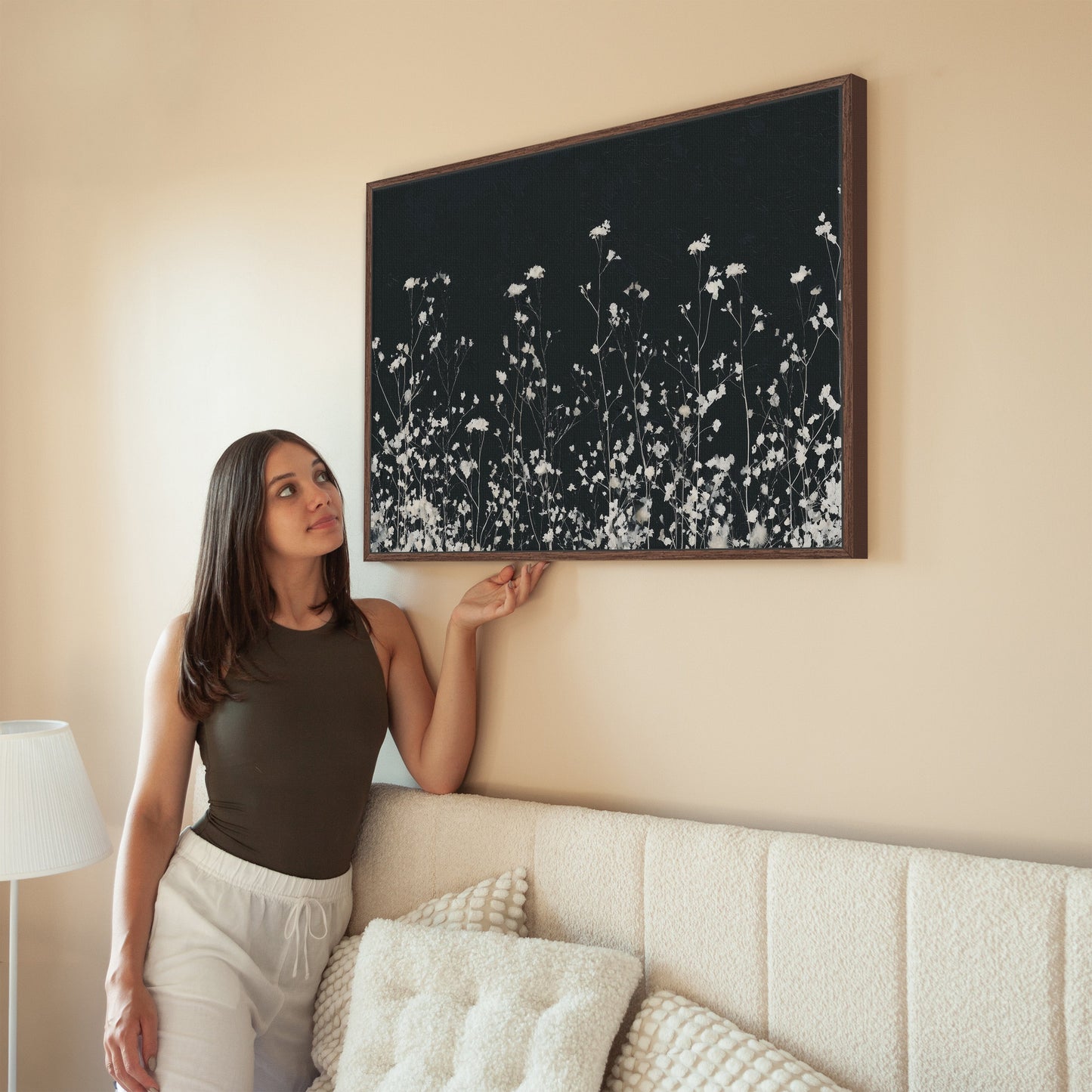 Noiré Canvas Wall Art featuring delicate white florals on deep charcoal background in solid wood frame above beige sofa