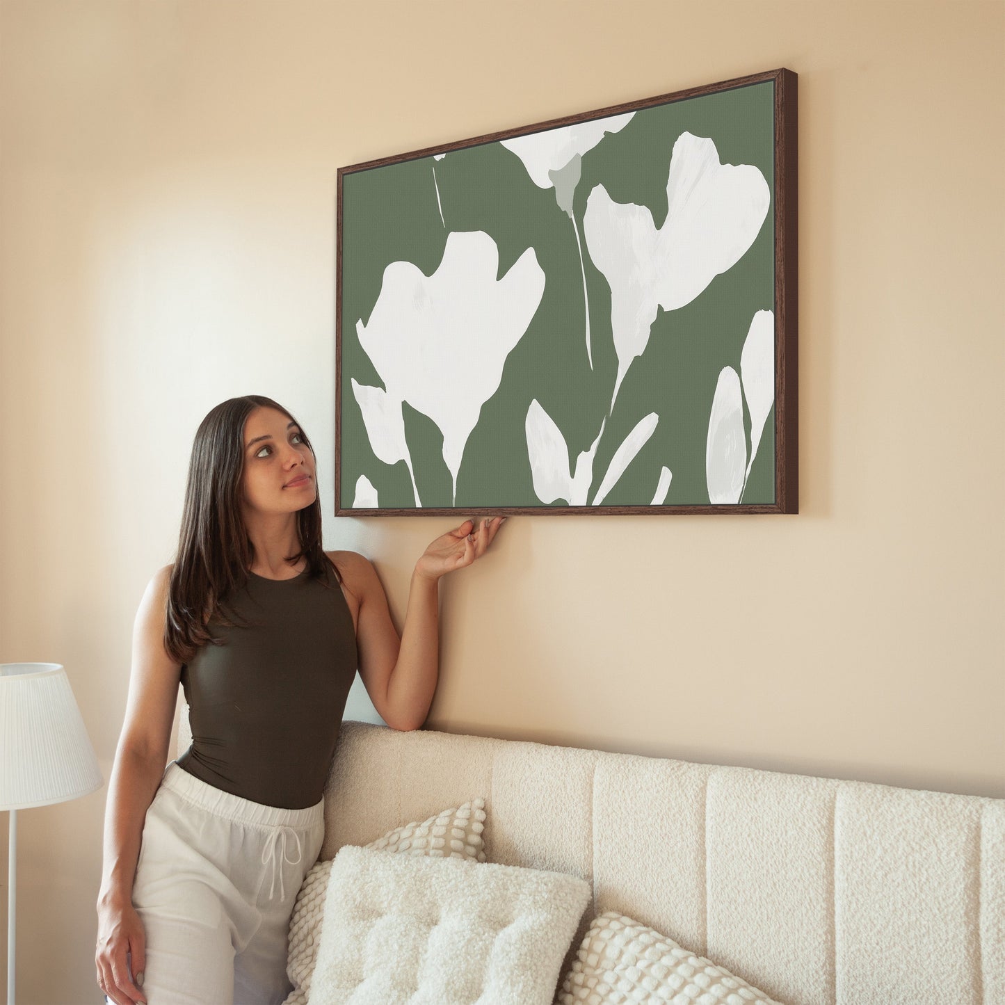 Verdal canvas print with ivory floral silhouettes on muted olive background in modern living room