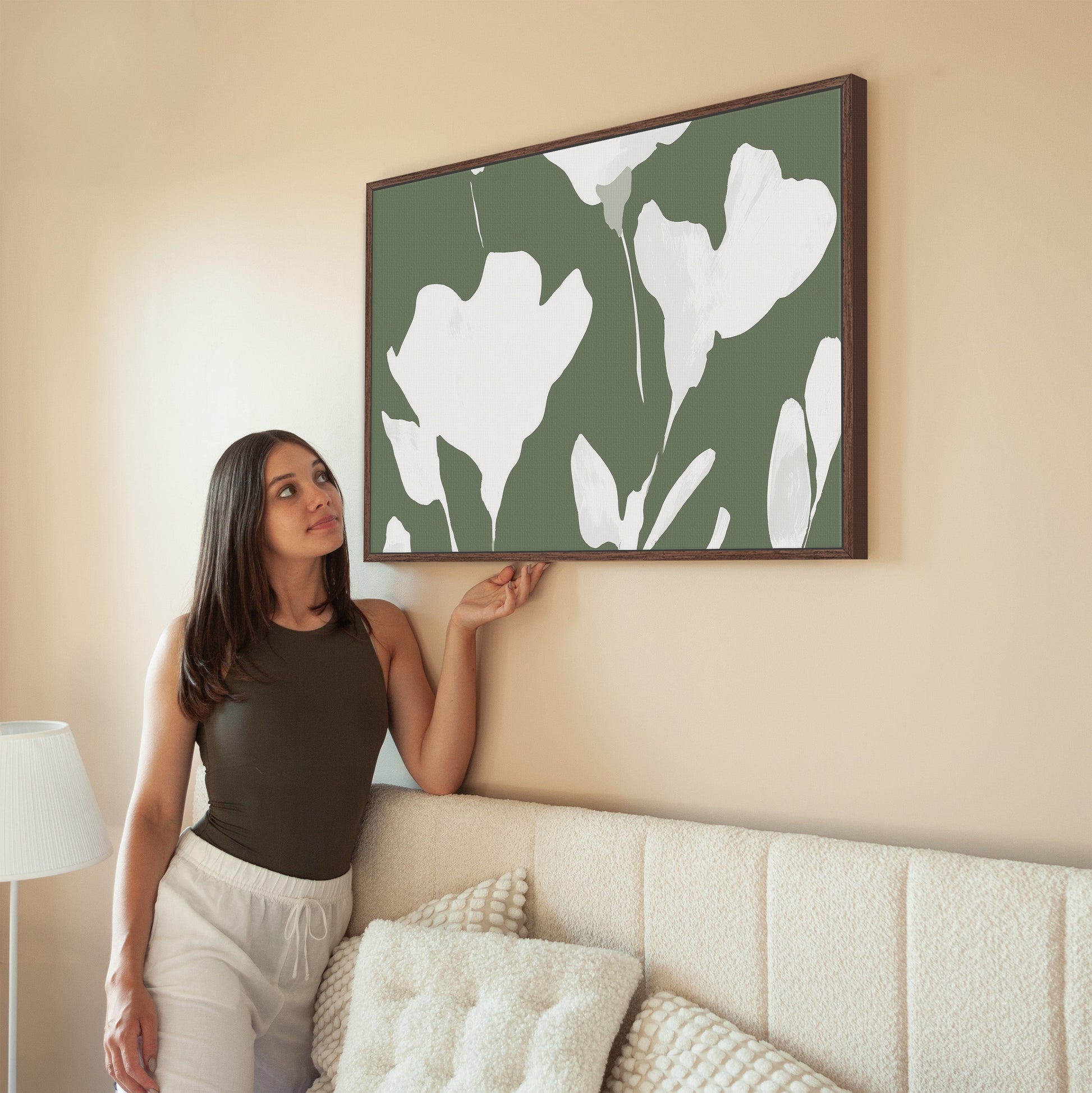 Verdal canvas print with ivory floral silhouettes on muted olive background in modern living room