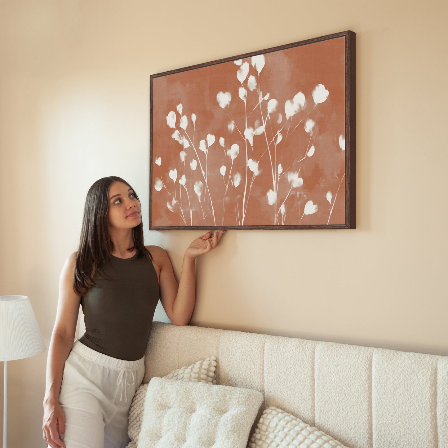 Ember canvas print with white floral design on terracotta background in modern living room setting
