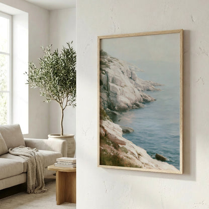 a serene living room with a large framed painting of a rocky coastline and a lush green tree in the corner, creating a calming and natural atmosphere.