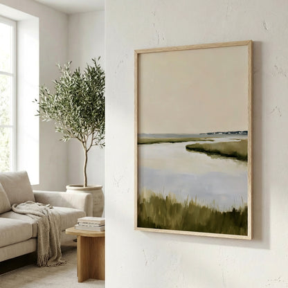a living room with a large painting of a serene landscape hanging on the wall, depicting a calm body of water and lush greenery.