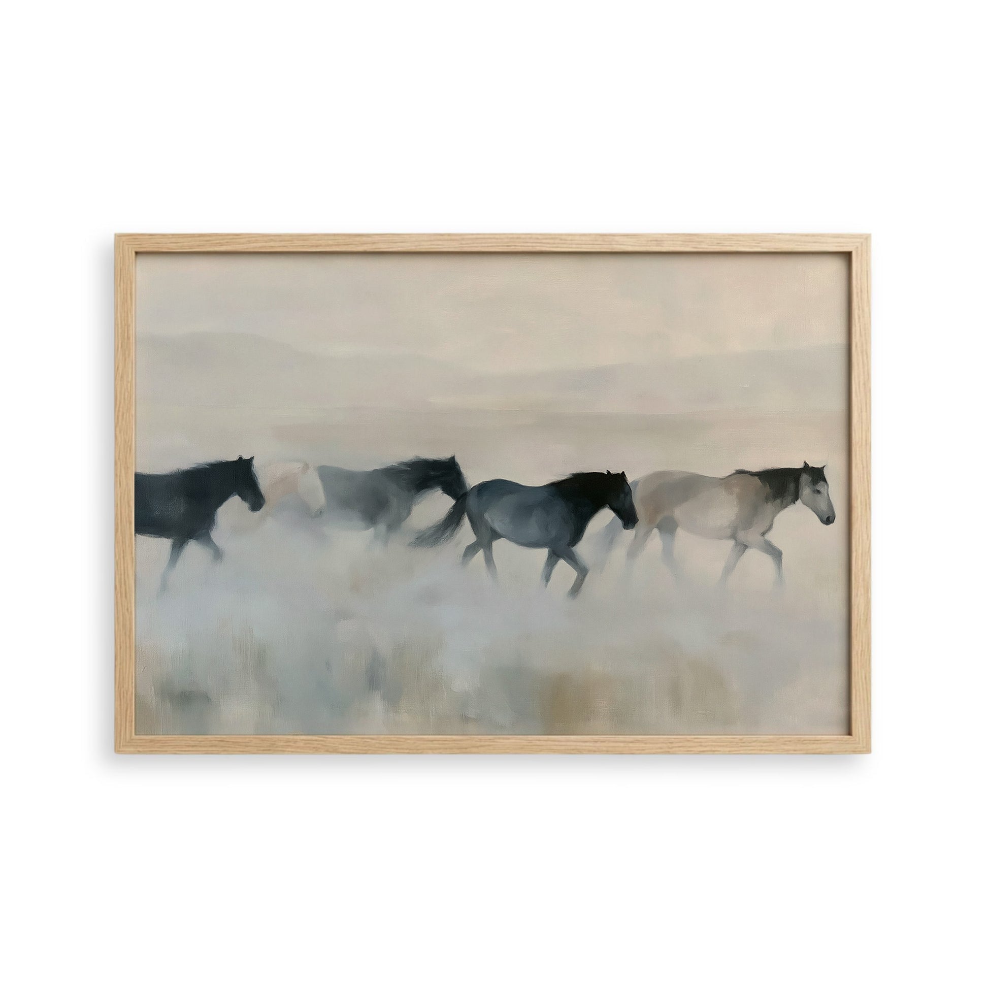 A group of horses running across a field, with a hazy, misty background.
