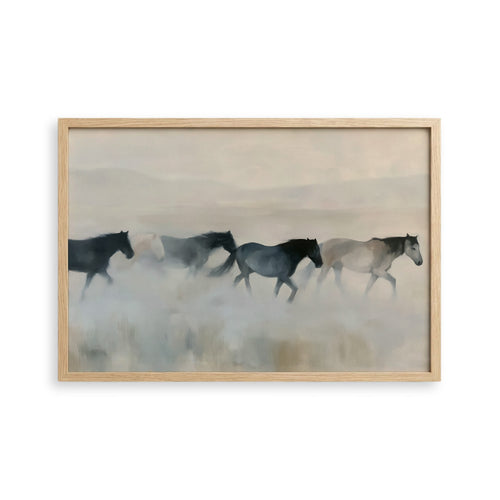 A group of horses running across a field, with a hazy, misty background.