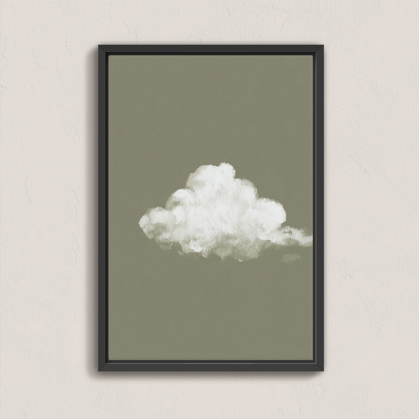 Minimalist 'Trace' canvas print featuring a single white cloud on a muted sage background in a black floating frame
