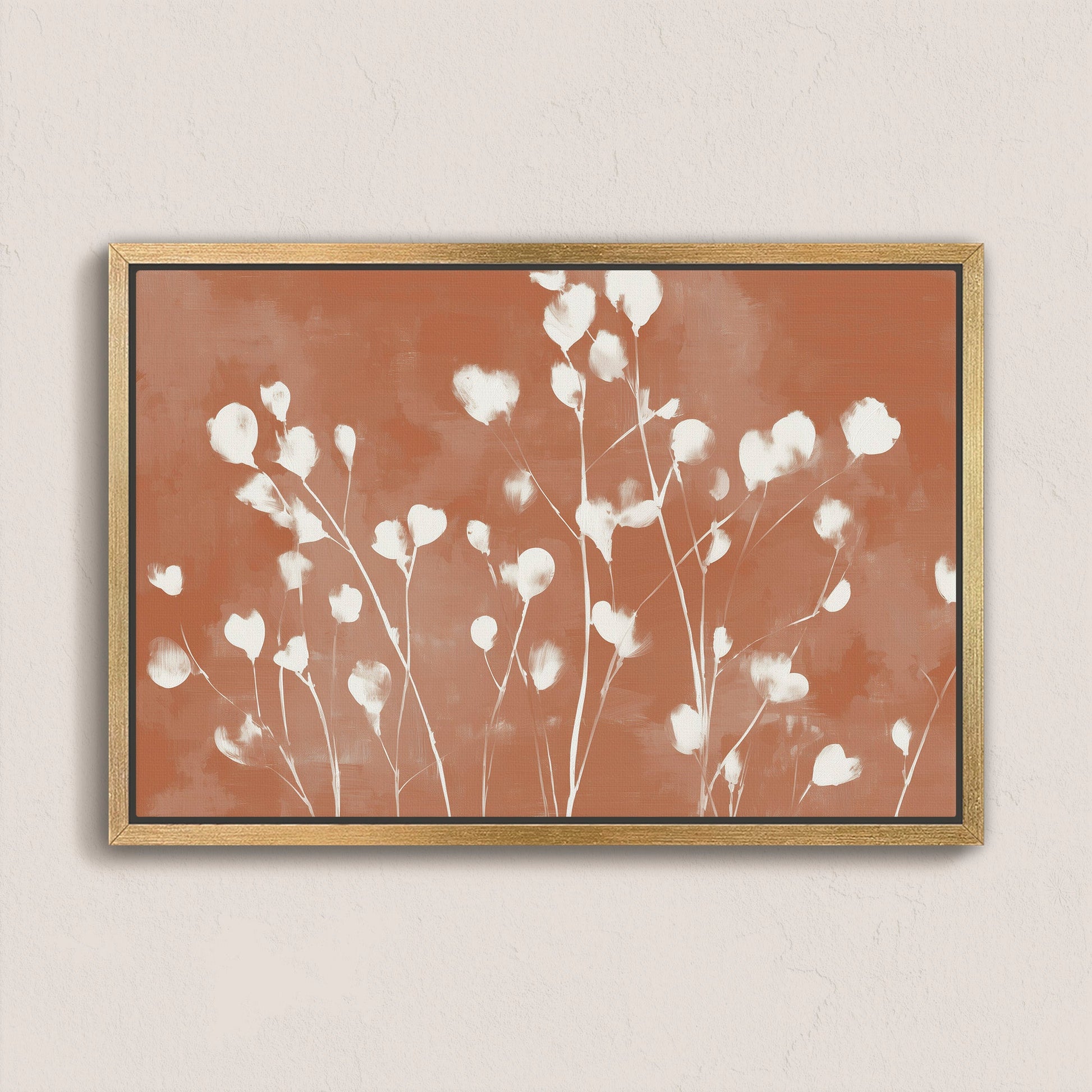 Ember canvas print with white floral silhouettes on terracotta background in natural wood frame