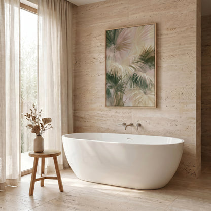 a serene and modern bathroom with a large white freestanding bathtub, a wooden stool, and a framed artwork featuring palm leaves on the wall.