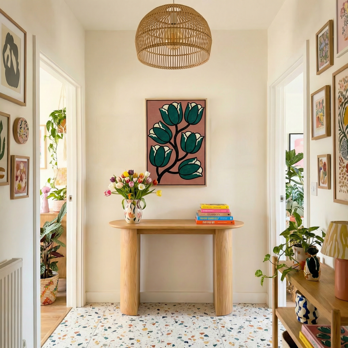 a well-decorated hallway with a wooden console table, a hanging light fixture, and a colorful abstract painting on the wall. The hallway is filled with various plants and artwork, creating a vibrant and inviting atmosphere.
