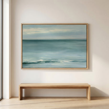 a large painting of a serene ocean scene hanging on a wall above a wooden bench.