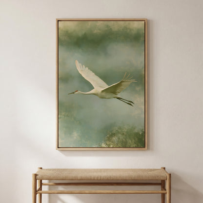 A large framed painting of a crane in flight hangs on a white wall above a wooden bench.