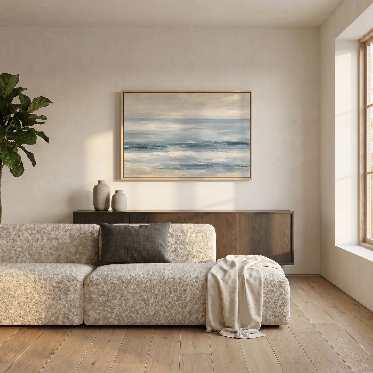 a serene living room with a large window, a white sofa, a wooden cabinet, and a framed painting of a blue sky with clouds hanging on the wall.