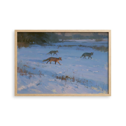 three foxes walking through a snowy field.