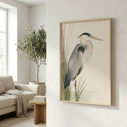 a framed painting of a heron, a tall wading bird, in a living room setting with a couch, a potted plant, and a wooden side table.