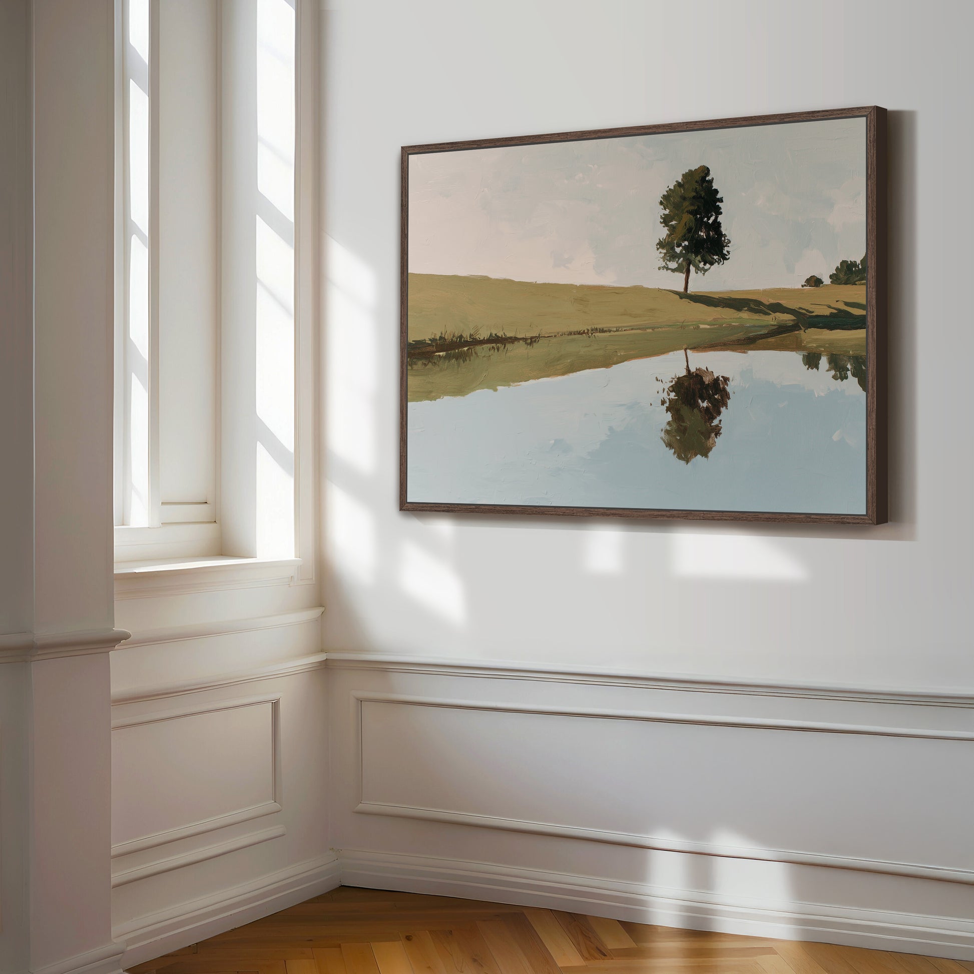 a large painting of a tree reflected in a calm body of water, hanging on a white wall in a room with a window.