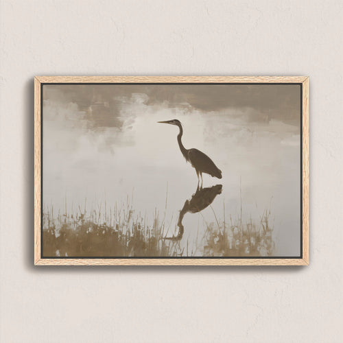 Wade canvas print of a heron standing in calm water with muted earth tones and soft light in a natural wood frame