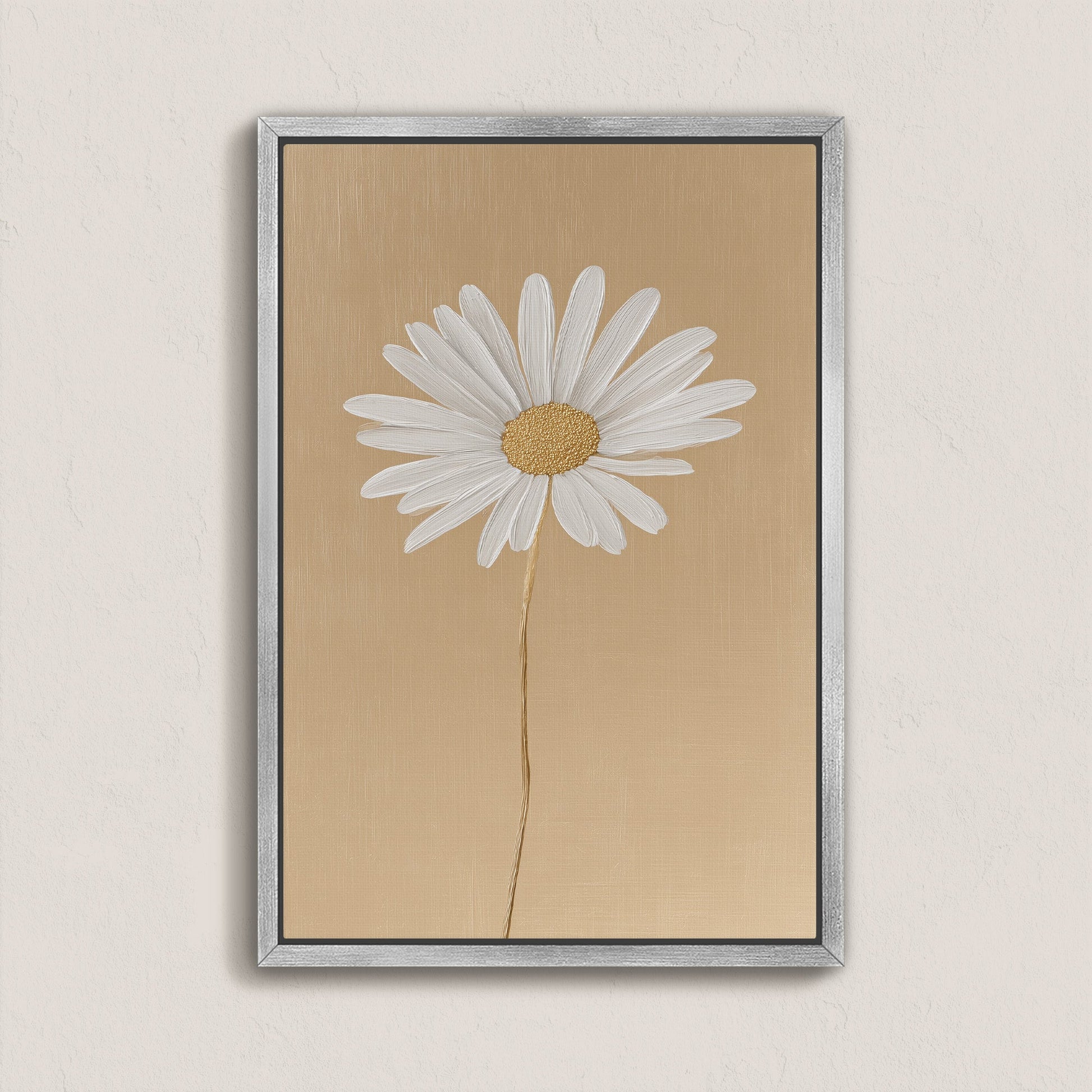 'Bloom' canvas print featuring a single white daisy on a golden-beige background with a silver frame, minimalist floral wall art
