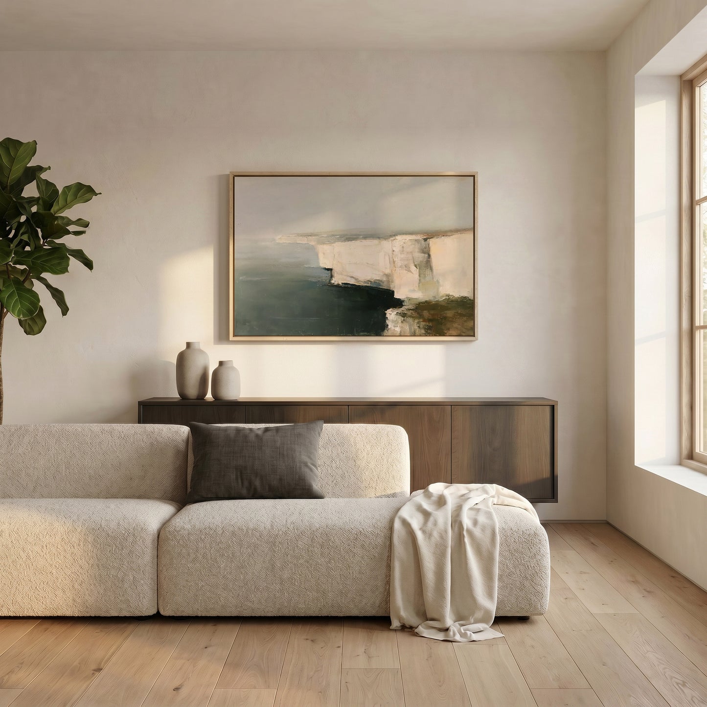 a modern living room with a large window, a white sofa, a wooden cabinet, and a framed landscape painting on the wall.